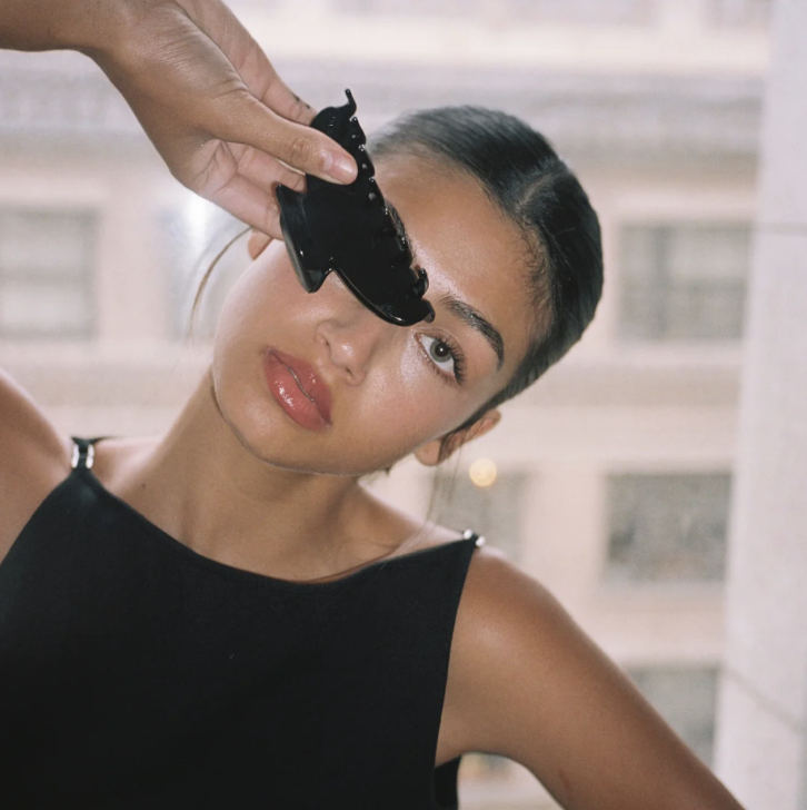 Holding a black Emi Jay hair clip